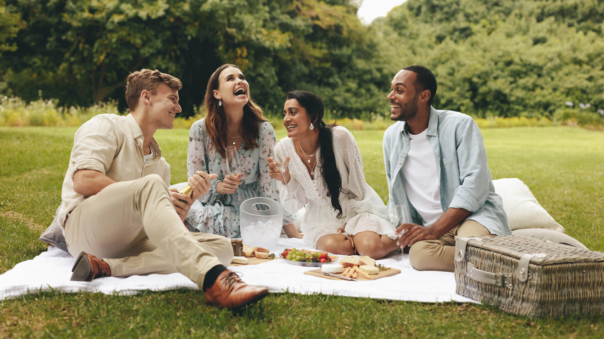 a group of friends sitting in the park having a picnic