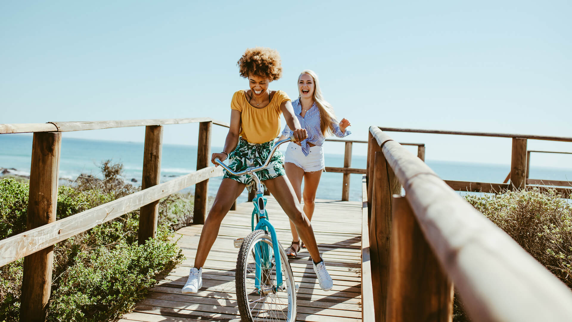 two friends on a pier smiling