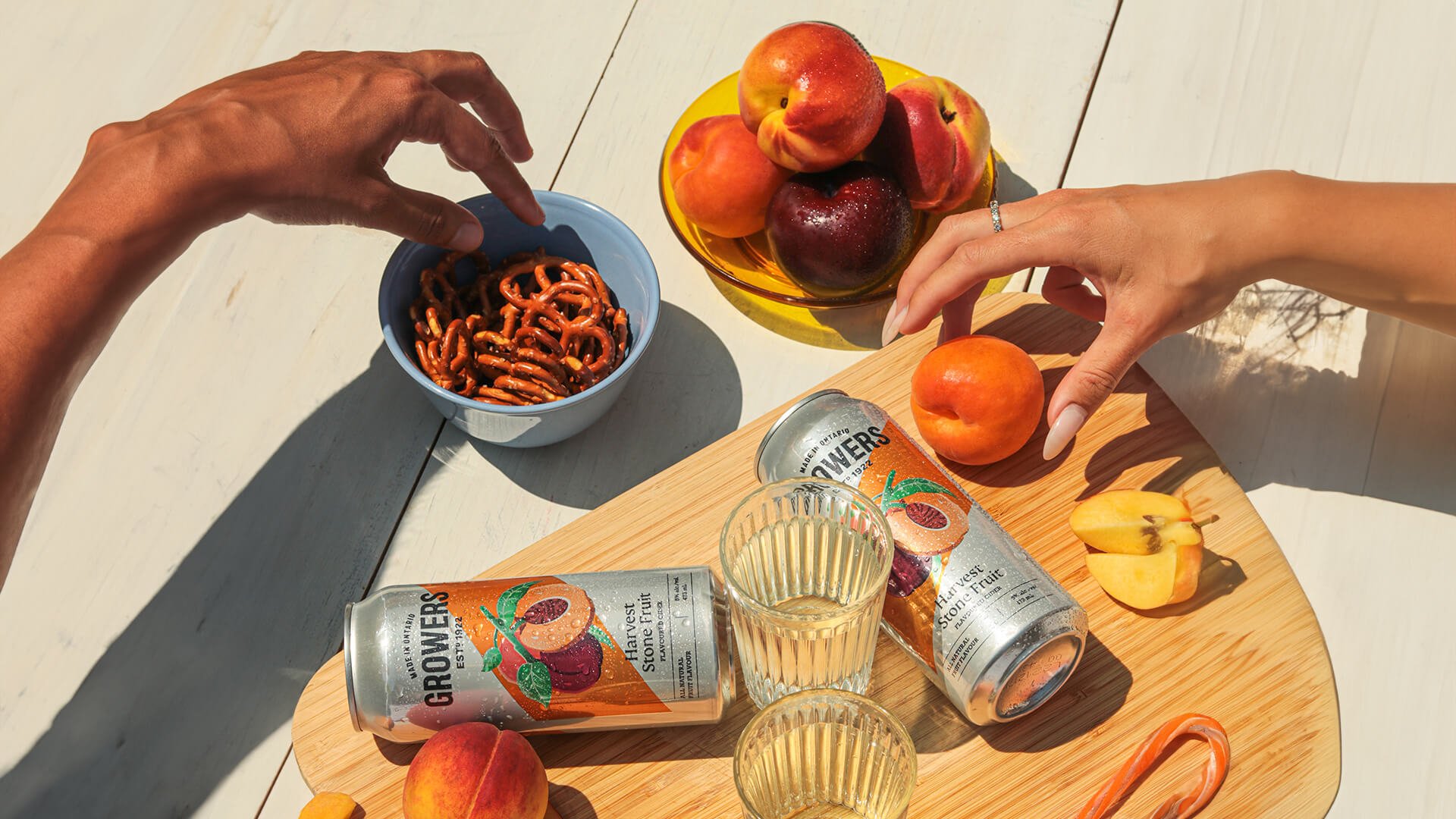 Growers stone fruit cider being enjoyed with snacks.